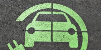 Zielony symbol ładowania samochodów elektrycznych na parkingu